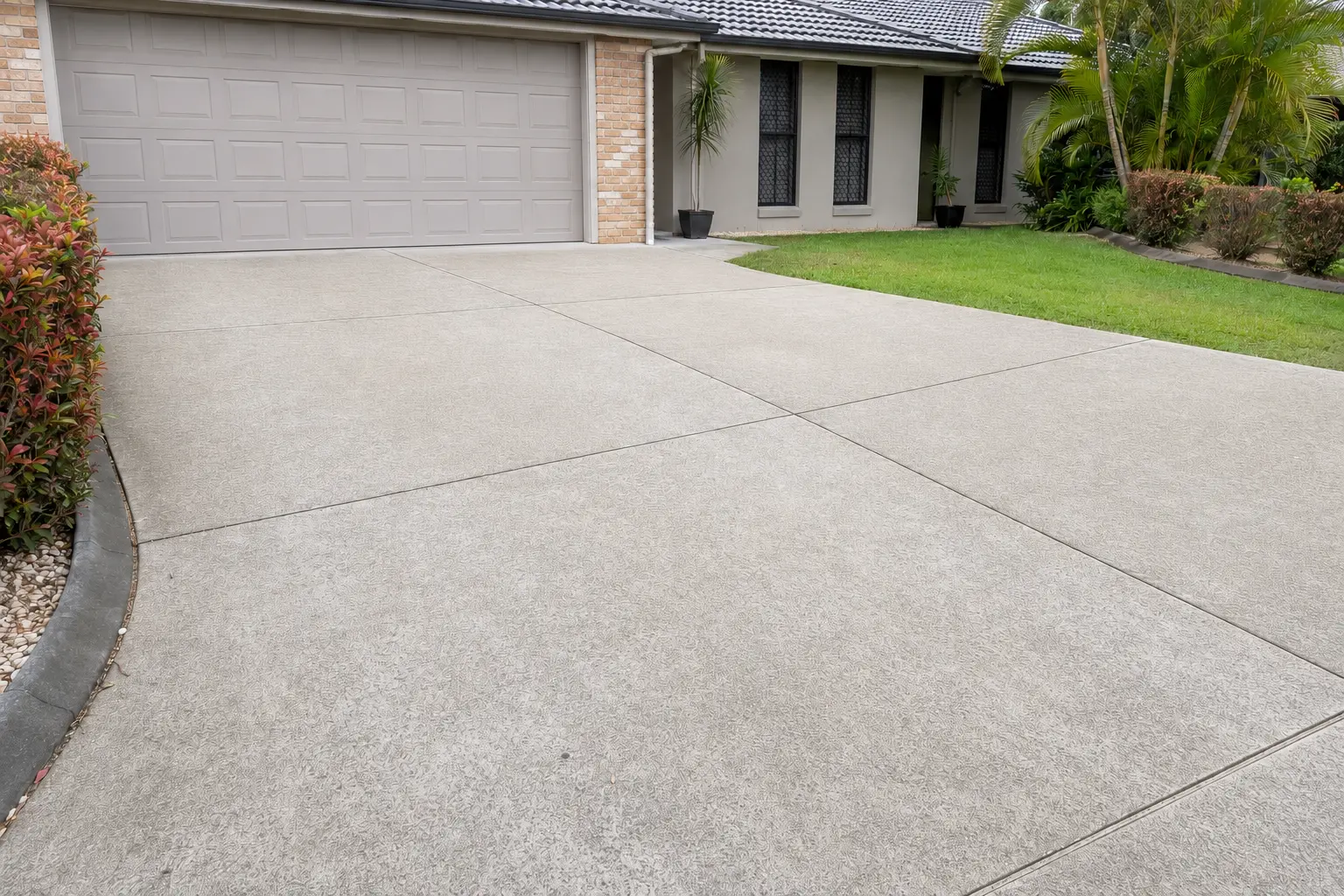 The same concrete driveway after pressure cleaning