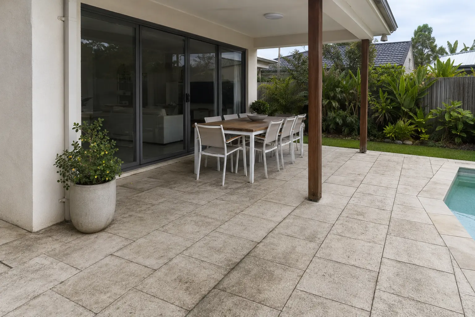 Covered outdoor patio before cleaning, with dull and stained paving